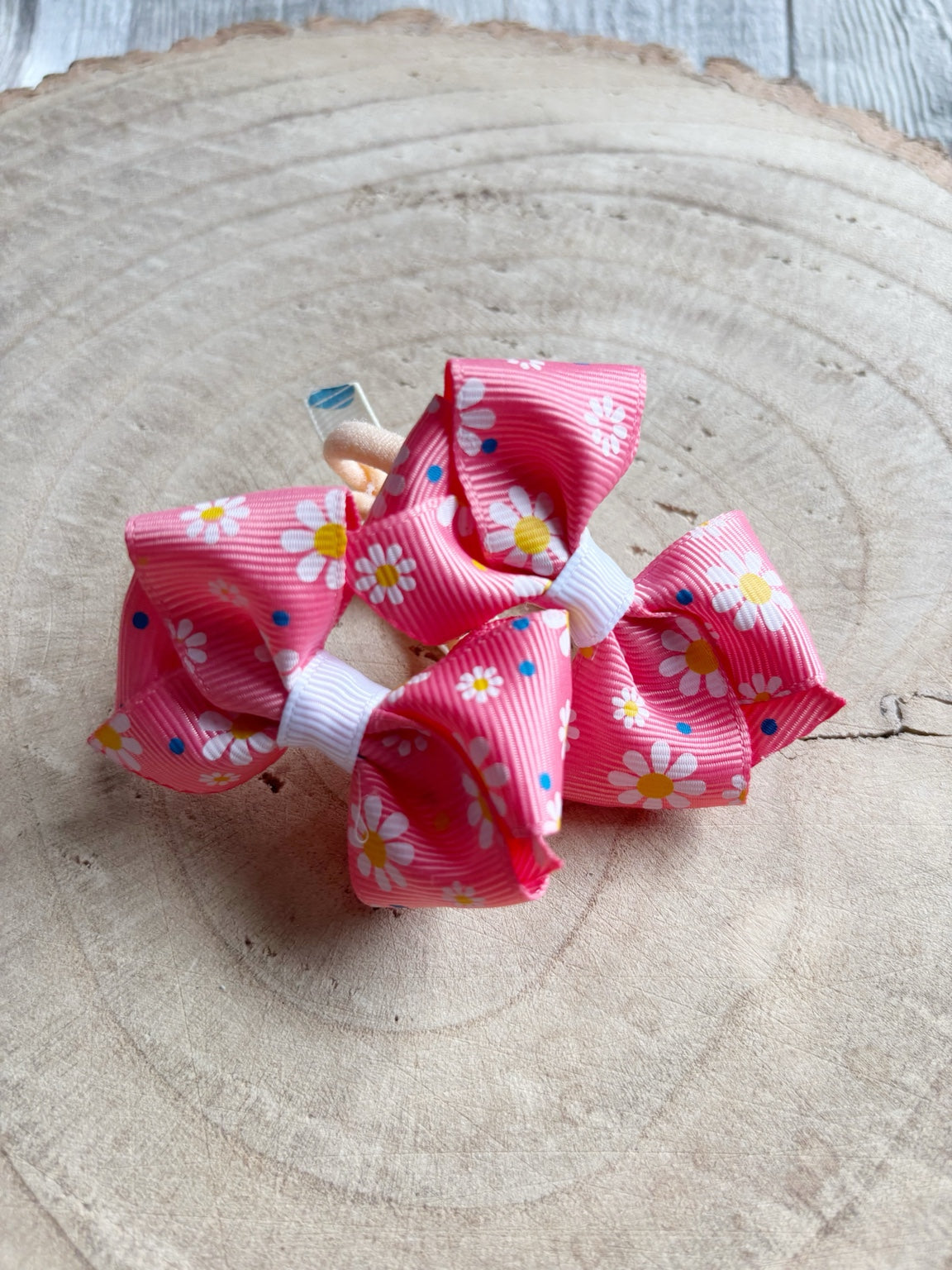 Pink daisy print bow hair bobbles pair close-up