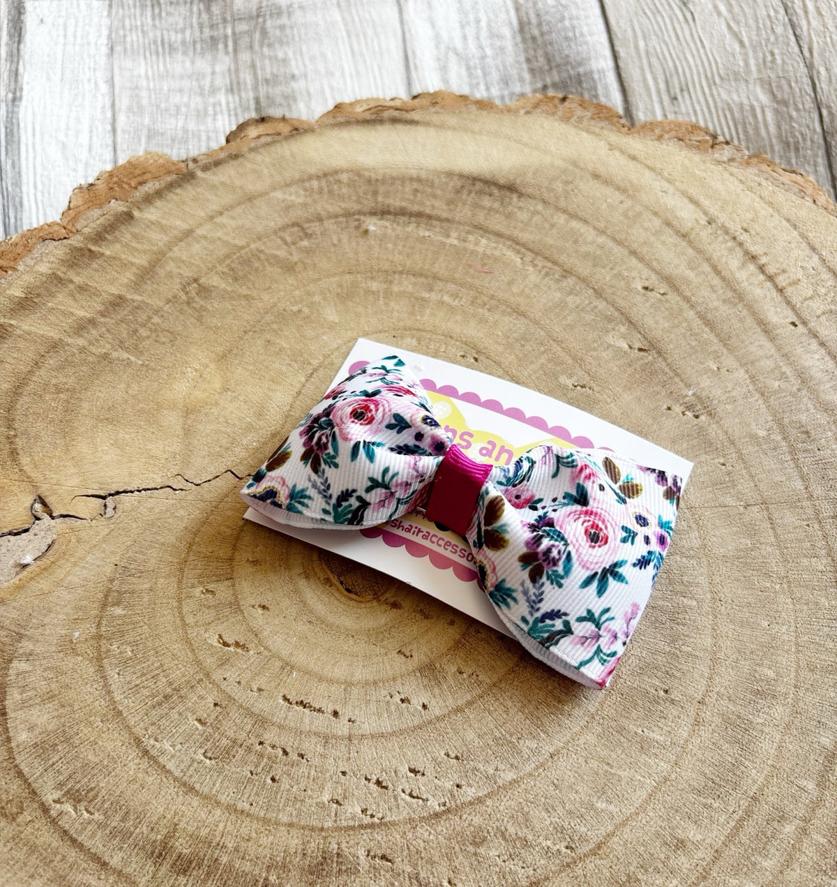 White floral handmade hair bow on Buttons and Bows display card