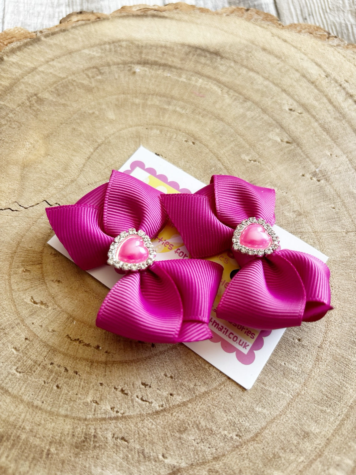 Bright pink handmade hair bow set with sparkly heart centres