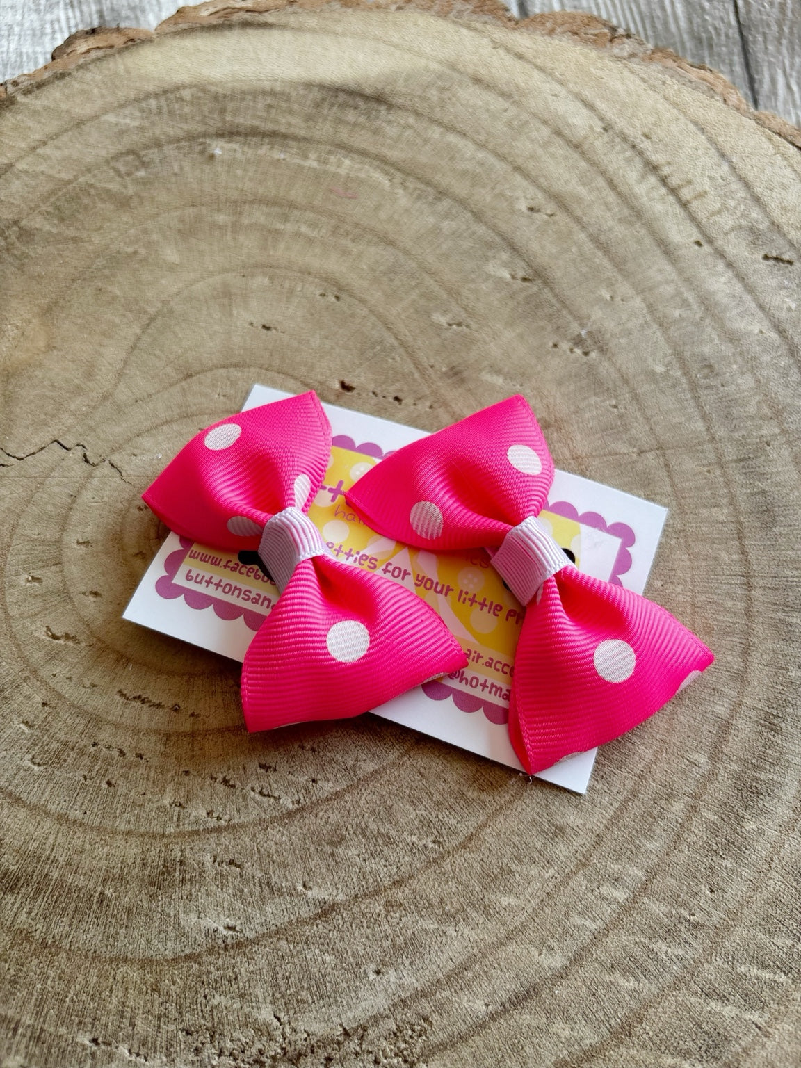 Pair of bright pink polka dot hair bows