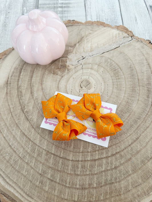 Orange and gold Halloween bow set handmade by Buttons and Bows