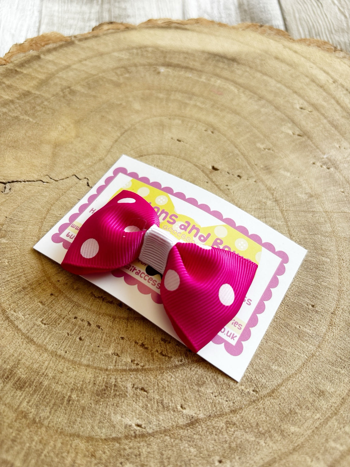 Bright pink and white polka dot handmade hair bow by Buttons and Bows