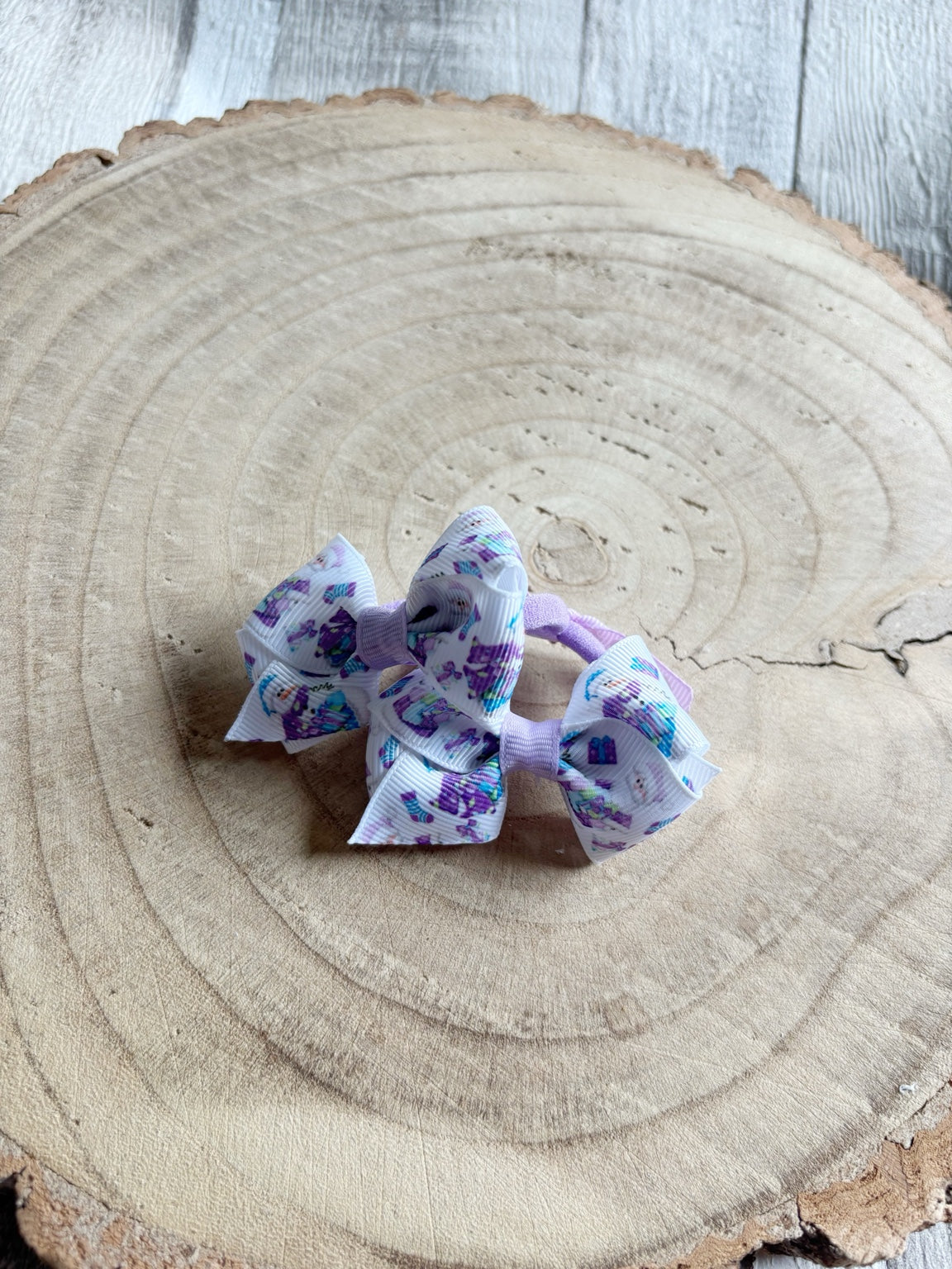 Purple princess bow hair bobbles pair close-up