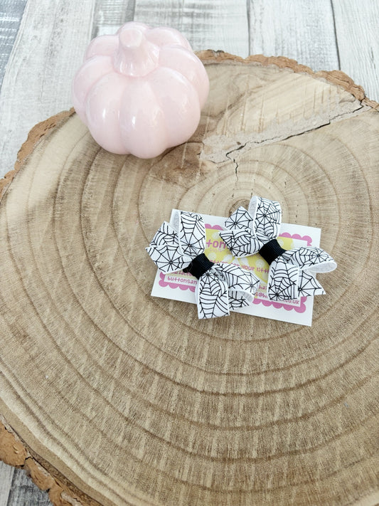 White spiderweb Halloween bow set handmade by Buttons and Bows